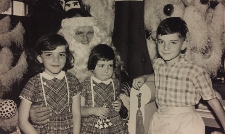Thee kids having photos with Santas in the 1960s